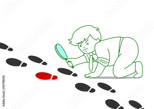 Man watching footprints through magnifying glass