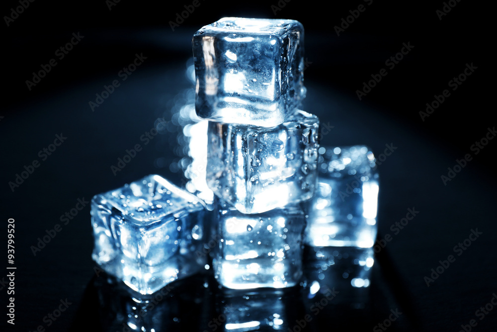 Shining ice cubes under blue light on liquid background Shining ice cubes under blue light on liquid background