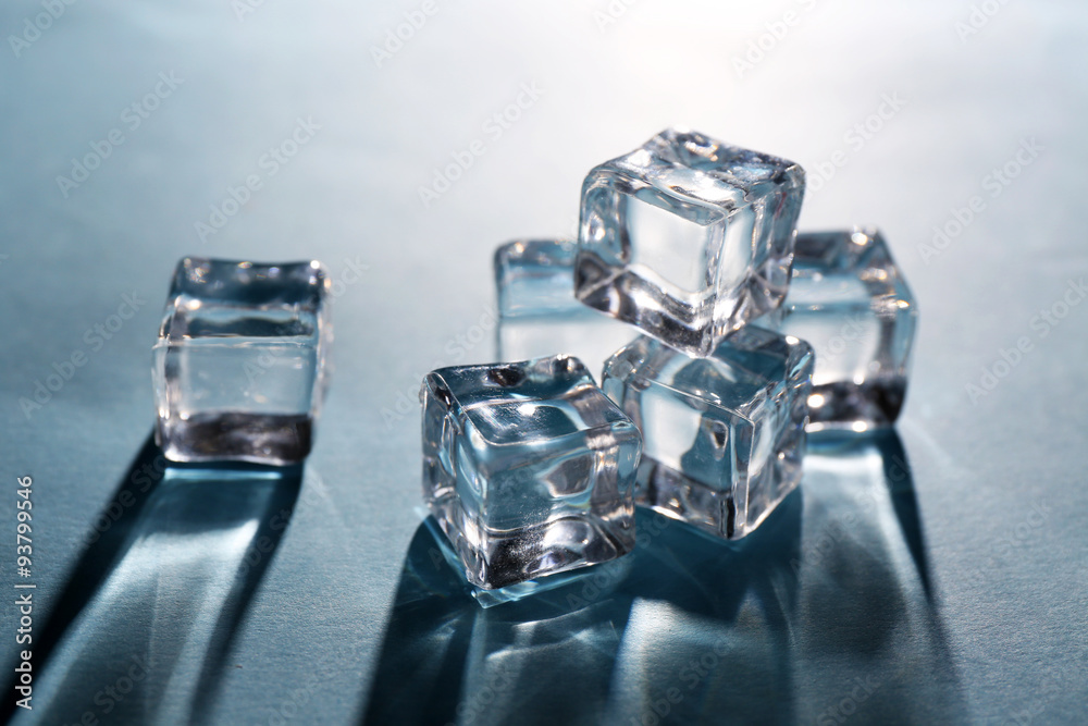 Shining ice cubes on grey-blue background Shining ice cubes on grey-blue background