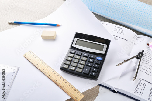 School supplies and textbook on mathematics close up