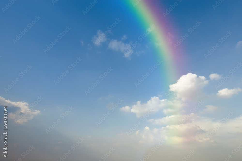 Clear blue sky with white cloud and rainbow Clear blue sky with white cloud and rainbow