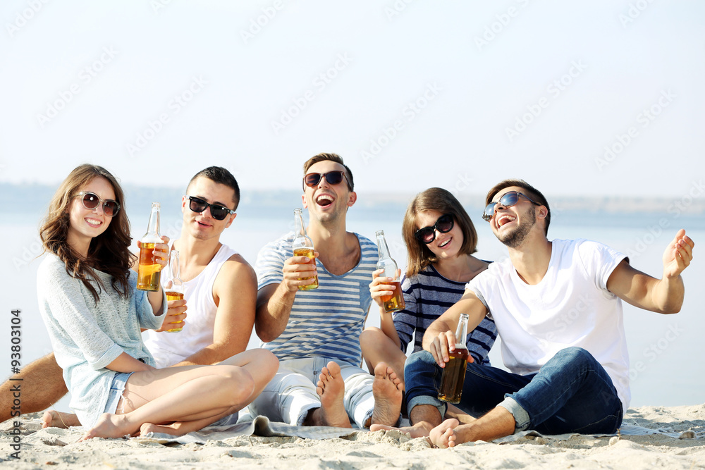 Young people with beer on the riverside Young people with beer on the riverside