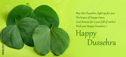 Indian Festival Dussehra, showing golden leaf on green background. Greeting card.