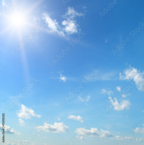 sun on blue sky with white clouds