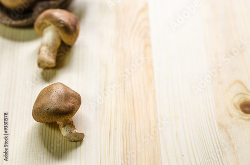 fresh shiitake mushrooms isolated on wooden table background