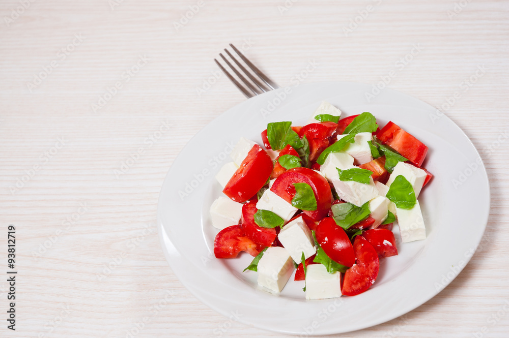 salad with cheese, tomatoes and basil