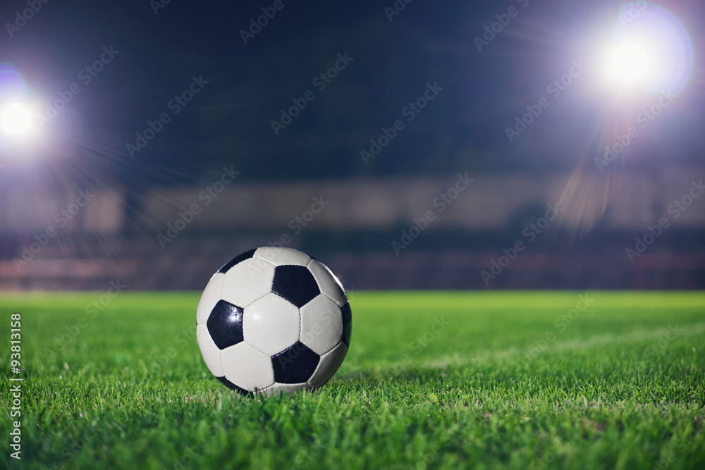 Soccer at night. Classical football on the playground, reflector made a beautiful lens flare in the background
