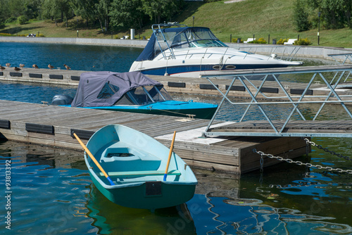 Rowboat and boats at the pier © Konstantin