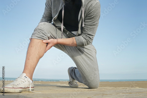Quadro su tela jogging man suffering from cramp muscle pain holding painful muscle