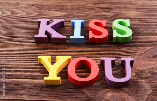 Wallpaper Mural Inscription KISS YOU made of colorful letters on wooden background Torontodigital.ca