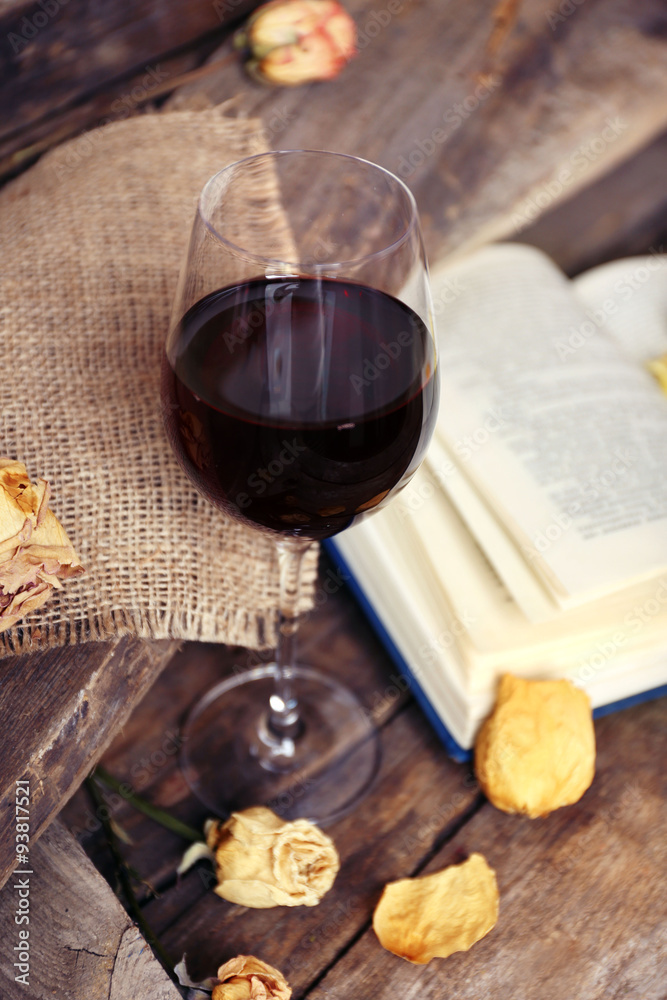 Beautiful composition with glass of wine with old book on table close up Beautiful composition with glass of wine with old book on table close up