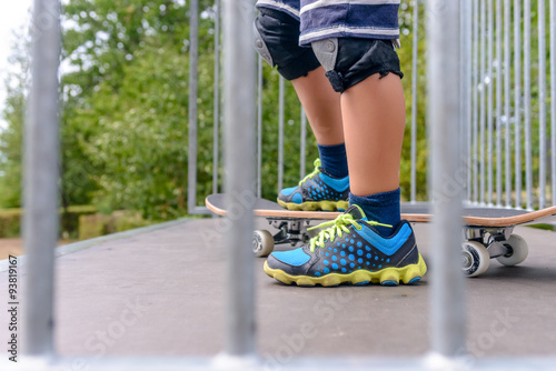 Young boy standing at the top of a ramp