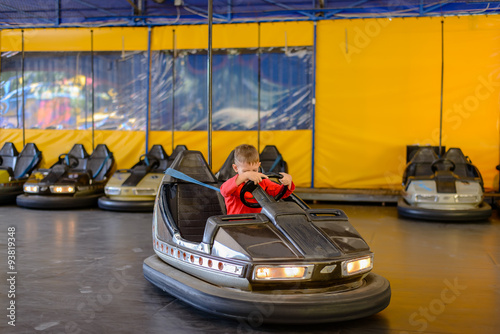 Young boy playing in a bumper car © Daddy Cool