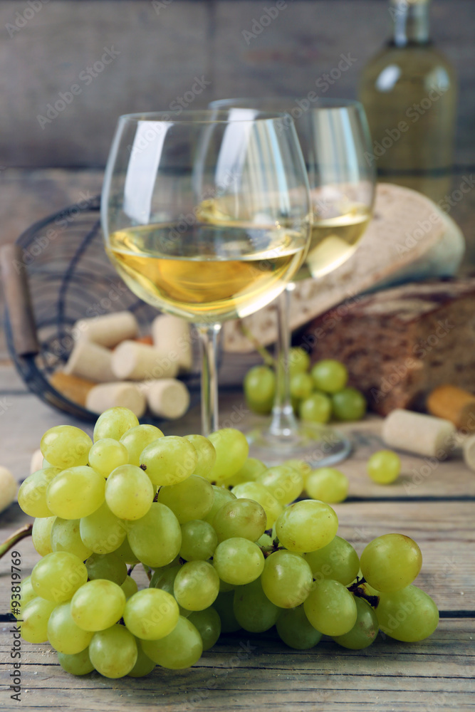 Still life of wine and bread on rustic wooden background