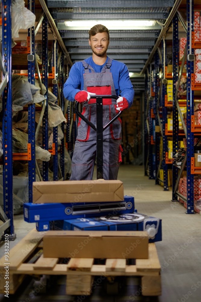Loader using hand pallet truck in a warehouse Loader using hand pallet truck in a warehouse