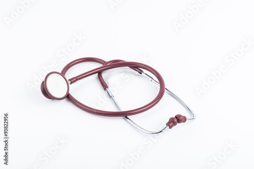 Red stethoscope medical equipment on white background