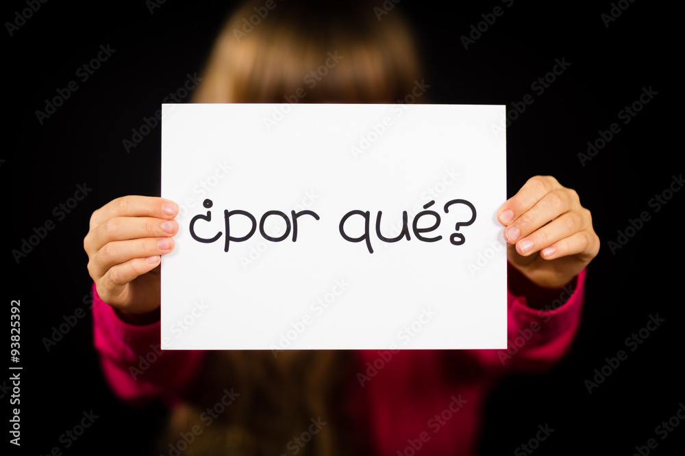 Fototapeta premium Child holding sign with Spanish words Por Que - Why