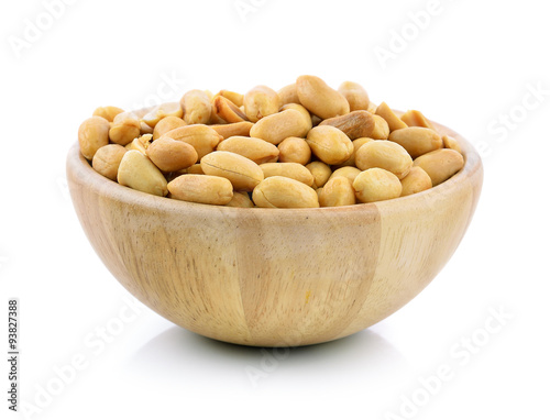 peanuts in a wood bowl on white background