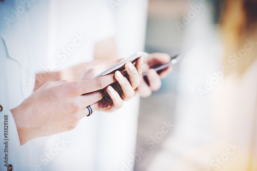 Young couple holding in hands their gadgets. Blurred background