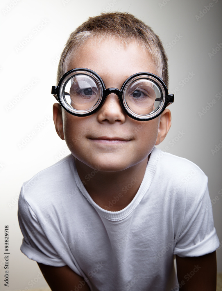 Portrait of a handsome little boy on the white wall background