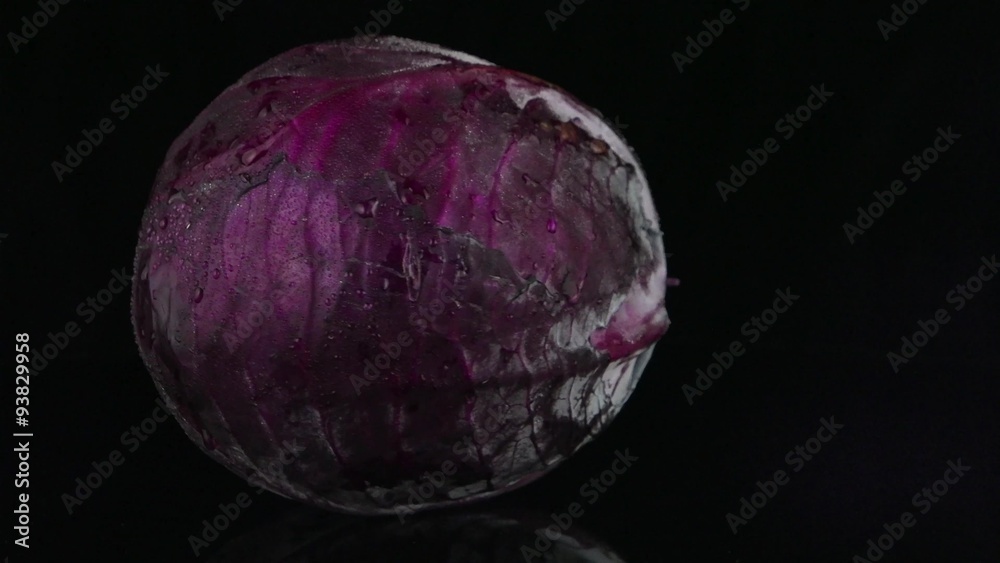 Red cabbage rotating over black background. Red cabbage rotating over black background.
