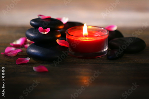 Spa stones and candles on dark background