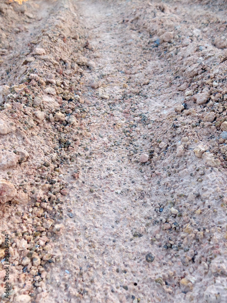 Wheel track in laterite soil excavation site, construction textu Wheel track in laterite soil excavation site, construction textu