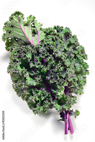 Kale leaves of red or Russian variety on white background.
