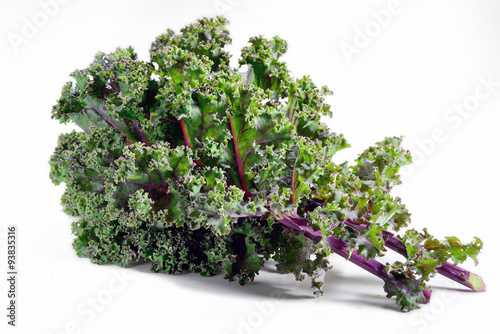 Kale leaves of red or Russian variety on white background.