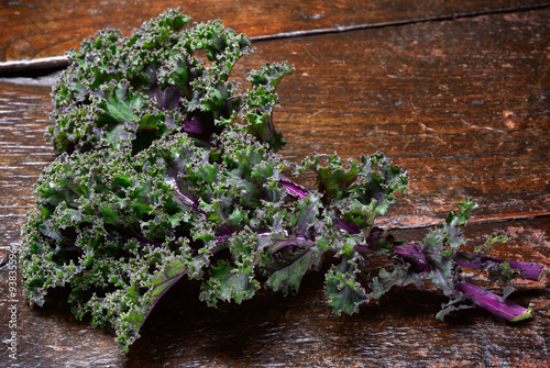 Kale, red or Russian variety on old, rustic wooden surface.