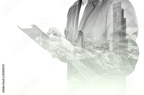 Double exposure of city and Businessman use Tablet device