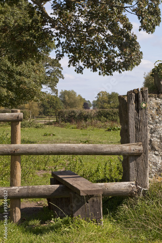 Across the Stile. Common on English country walks, a stile is provided for walkers to be able to get over the fences on the marked public walkpaths. photo