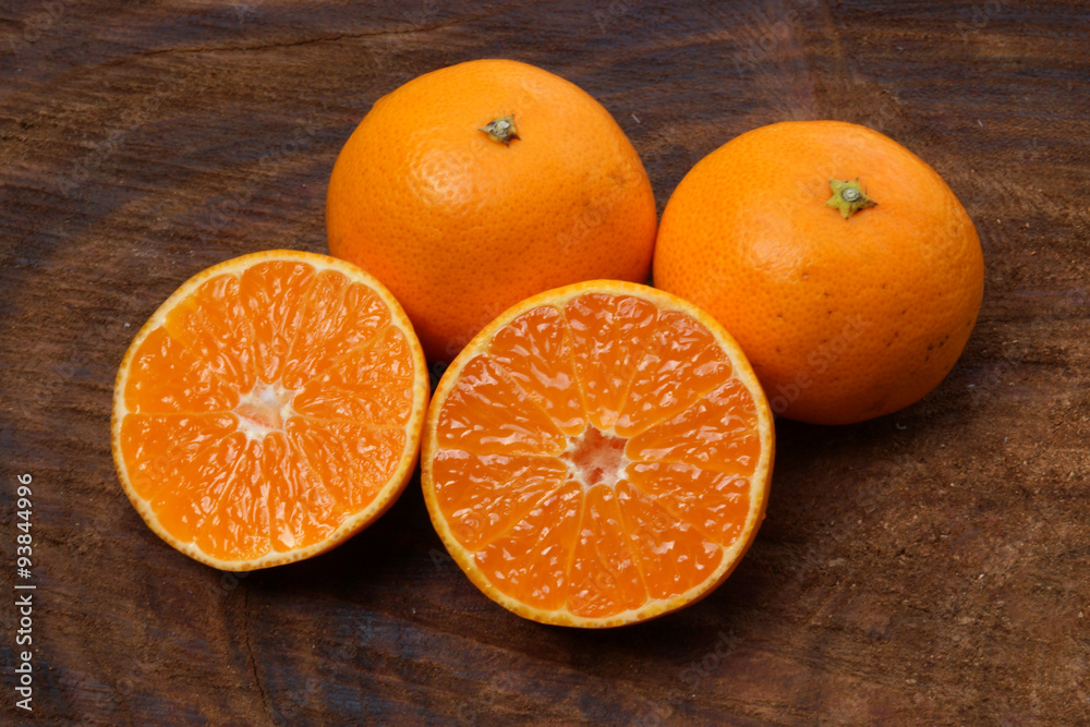 Fresh oranges on wood background.