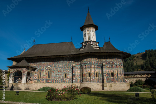 Sister walking next to Sucevita church