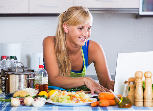 Woman searching recipe in internet