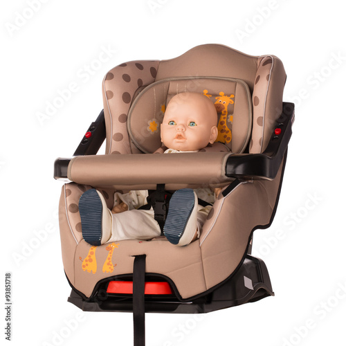 Baby doll in a booster seat for a car photo