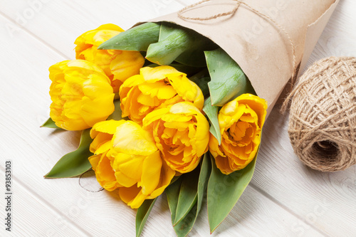 Yellow tulips over wooden table #93853103