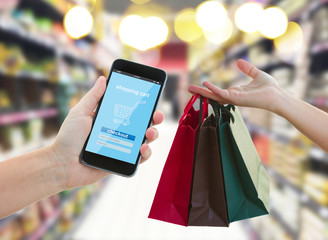 hand holding a modern smartphone in supermarket