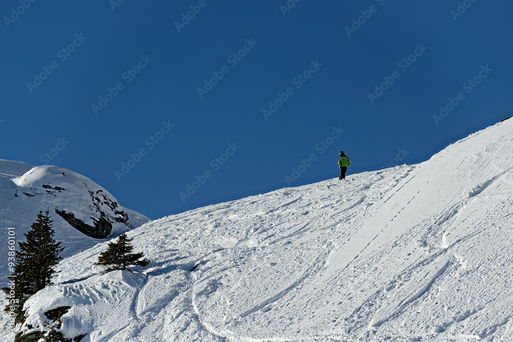 The boy on skis in mountains