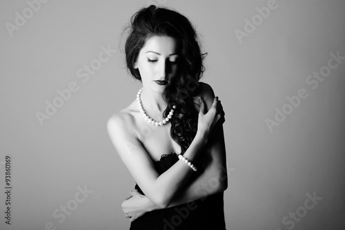 Black and white contrast portrait of beautiful woman with perls