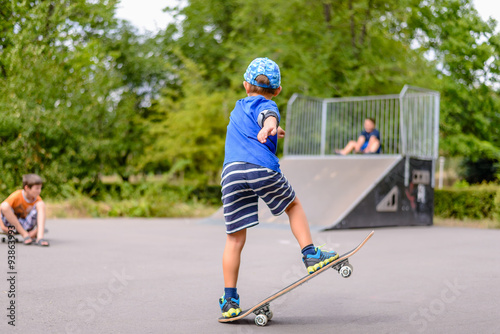 Small boy playing with his skateboard