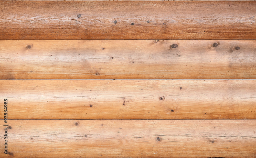 Wooden wall made of logs. Natural background Wooden wall made of logs. Natural background
