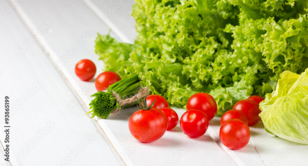 lettuce salad, tomatoes and green onion on white background lettuce salad, tomatoes and green onion on white background