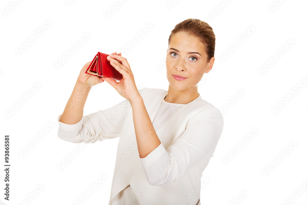 Shocked businesswoman looking into her empty wallet Shocked businesswoman looking into her empty wallet