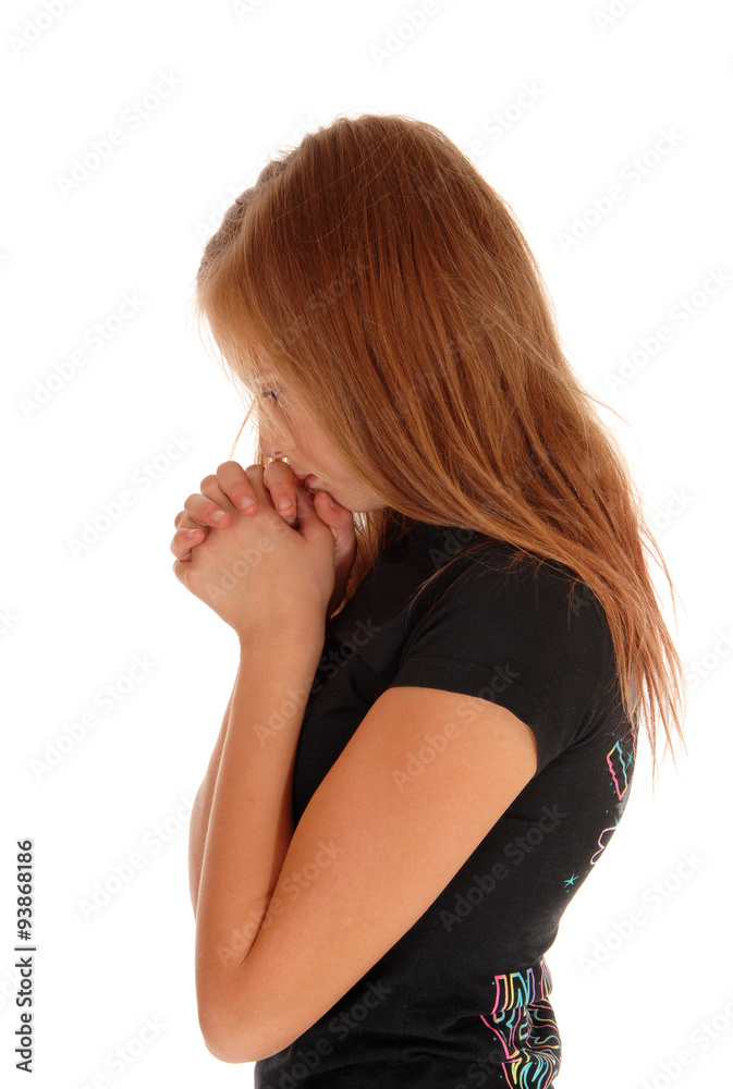 Girl standing in profile and praying. Girl standing in profile and praying.
