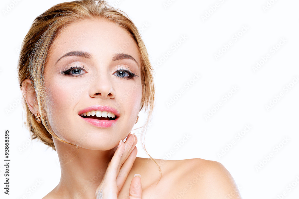 Studio shot of a beautiful young woman with perfect skin against Studio shot of a beautiful young woman with perfect skin against