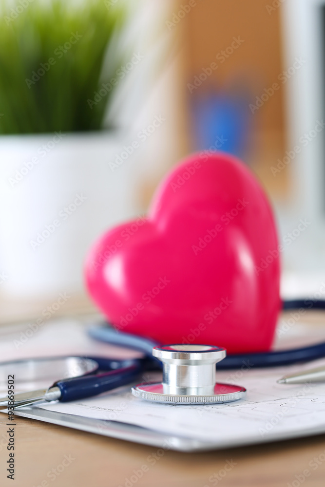 Medical stethoscope head and red toy heart Medical stethoscope head and red toy heart