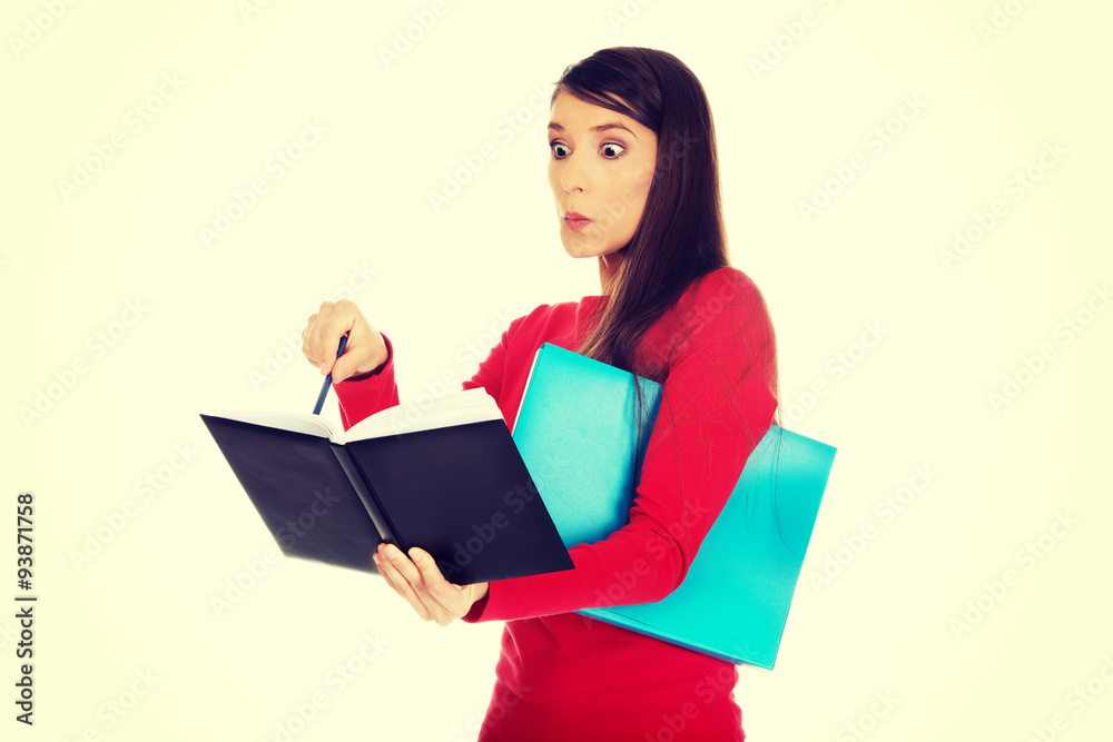 Shocked student woman with her note. Shocked student woman with her note.