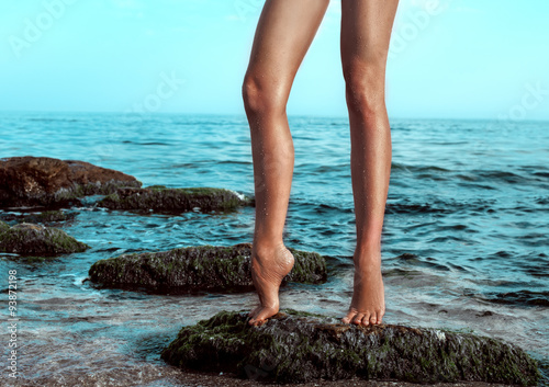 Woman's legs at beach jetty