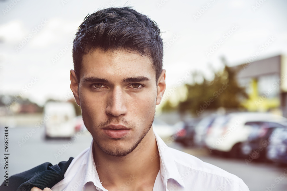 Attractive young man's headshot in urban environment 